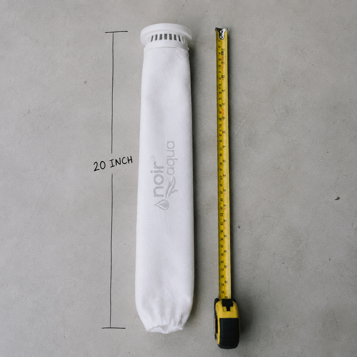The filter bag laid beside a tape measure showing its 20 inch length