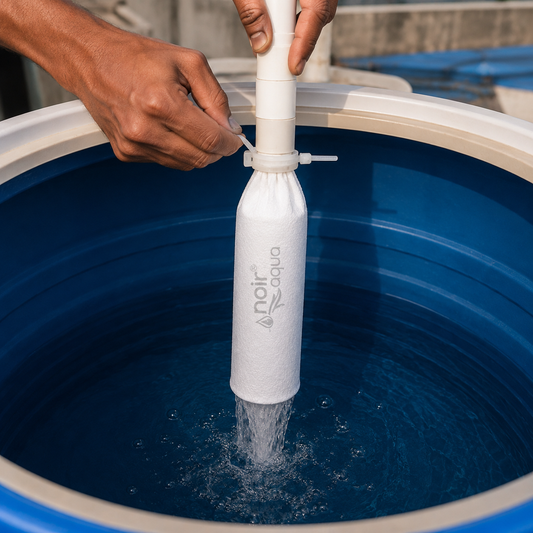 The filter bag clamped to the inlet pipe inside a blue water tank, with filtered water running out of the bottom of the bag